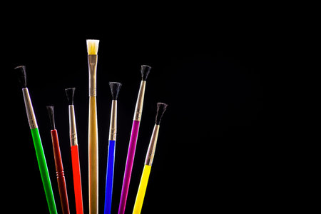 Concept of painting, colorful brushes on a black background - contour