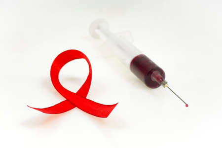 Health protection concept, aids, syringe and red ribbon on white backgroundの写真素材