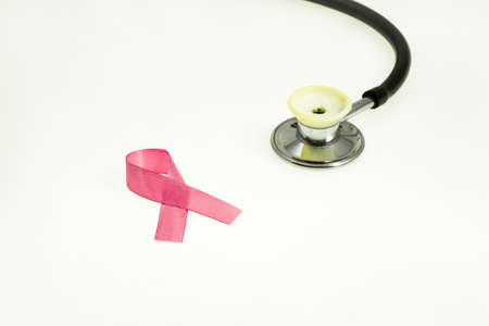 Concept for health protection, breast cancer, stethoscope and pink ribbon on a white backgroundの写真素材