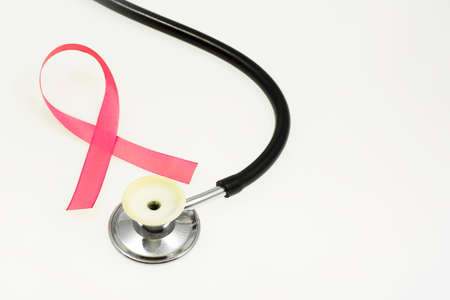 Concept for health protection, breast cancer, stethoscope and pink ribbon on a white backgroundの写真素材