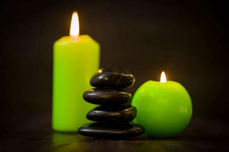 SPA concept, stones and candles on a dark backgroundの写真素材