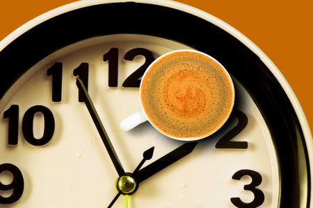 Cup of coffee on the background of the clock