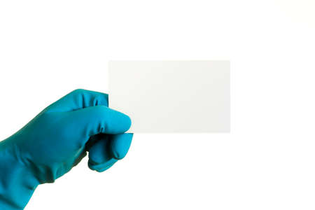 Hand in a blue glove holding a sticky note with space for text, isolated on white, isolatedの写真素材
