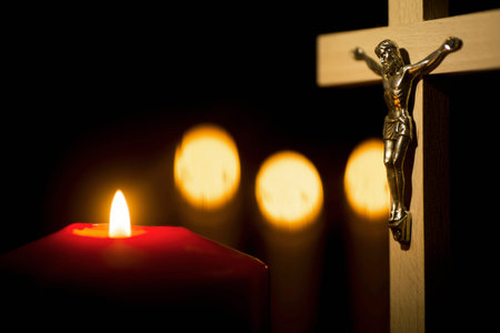 Wooden cross with lighted candles on a black background