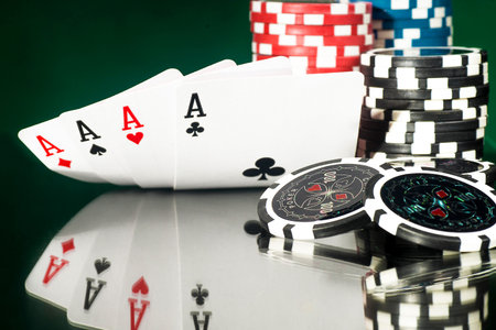 Gambling concept - Cards on a background of chips with a reflection