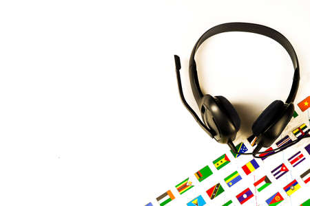 Headphones with a microphone on a white background and national flagsの写真素材