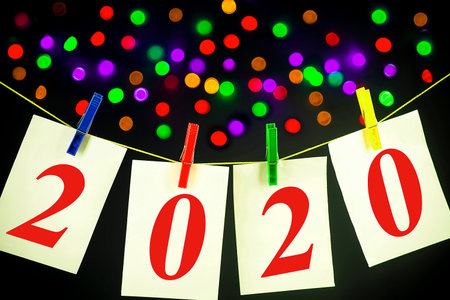 New Year concept - Bright Cards with an inscription 2020 on a line attached with colorful clasps on...