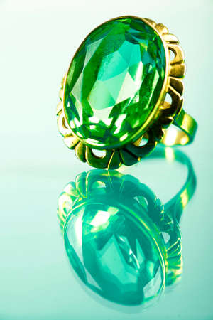 Gold-rimmed ring with sapphire on light sapphireの写真素材