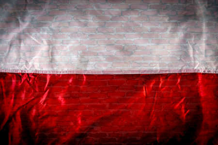White-red flag on the background of a brick wallの写真素材