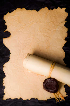 Papyrus scrolls with a seal on a dark dressの写真素材