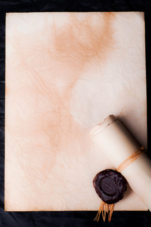 Papyrus scrolls with a seal on a dark dress