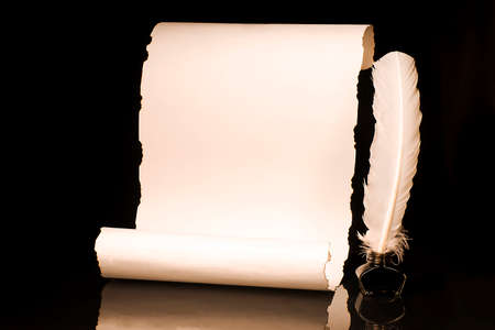 Unrolled papyrus scroll with inkwell and bird featherの写真素材