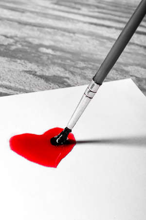 Brush painted red heart on a sheet of paperの写真素材