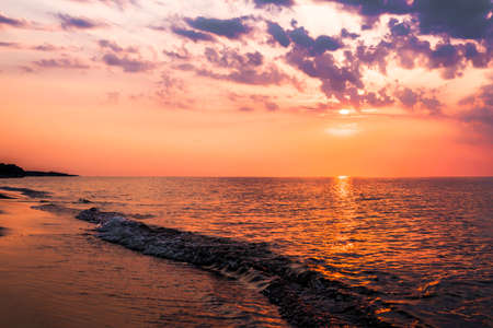 The concept of travel and rest at the seaside, sea waves on the background of the beachの写真素材