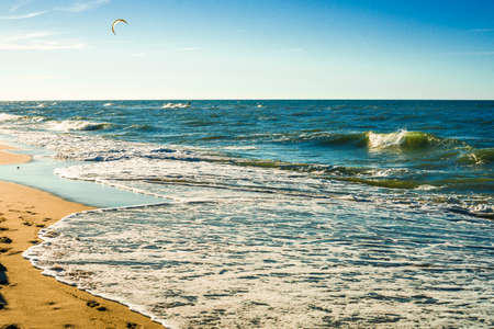 The concept of travel and rest at the seaside, sea waves on the background of the beachの写真素材