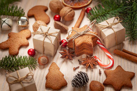 Christmas - a composition of gingerbread, nuts, spices, firs, bells and giftsの写真素材