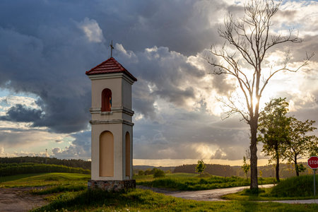 Field chapel in Gietrzwald - a village in Warmia and Mazury, Poland - spring landscape, falling rain, sunset.の写真素材