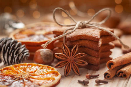 Christmas - a composition made of homemade gingerbreads, nuts, anise, cinnamon sticks, horsemen and dried orangesの写真素材