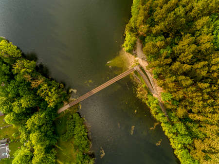Olsztyn Lake Dlugie, bird's eye view. Wooded shores, the sky reflecting in the water table and a bridge over the lake - Warmia and Masuria, Polandの写真素材