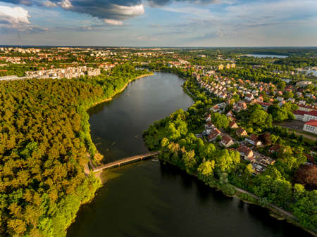 Olsztyn Lake Dlugie, bird's eye view. Wooded shores, the sky reflecting in the water table and a bridge over the lake - Warmia and Masuria, Polandの写真素材