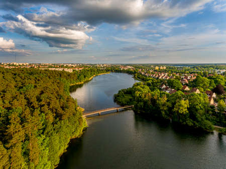 Olsztyn Lake Dlugie, bird's eye view. Wooded shores, the sky reflecting in the water table and a bridge over the lake - Warmia and Masuria, Polandの写真素材