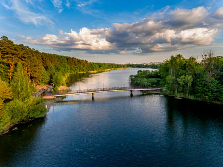 Olsztyn Lake Dlugie, bird's eye view. Wooded shores, the sky reflecting in the water table and a bridge over the lake - Warmia and Masuria, Polandの写真素材