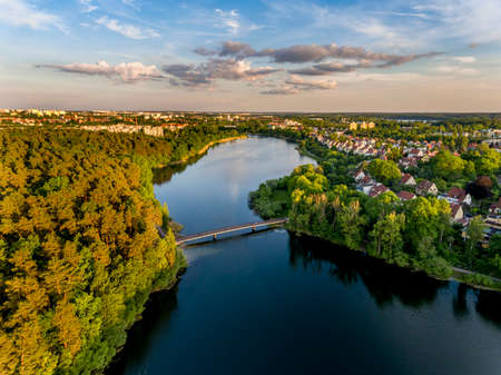 Olsztyn Lake Dlugie, bird's eye view. Wooded shores, the sky reflecting in the water table and a bridge over the lake - Warmia and Masuria, Polandの写真素材