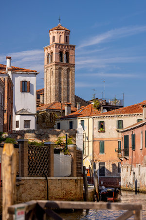 Venice, Rio de la ca 'en Duo canal and San Martino church bell tower - old buildings, boat.の写真素材