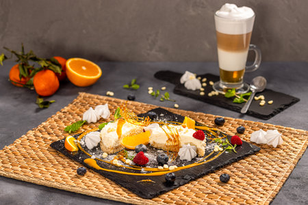 White chocolate cheesecake served with roasted peanuts and mango sauceの写真素材