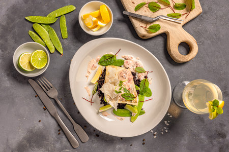 Zander served with black risotto with chanterelles, sugar peas and apple and wine mousseの写真素材