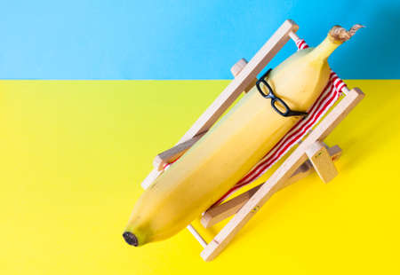 Banana with sunglasses on the sunbed. Summer holiday concept.の写真素材