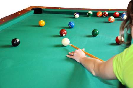 Girl playing billiard, preparing to shot