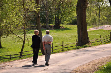 Senior couple walking through the forrestの写真素材