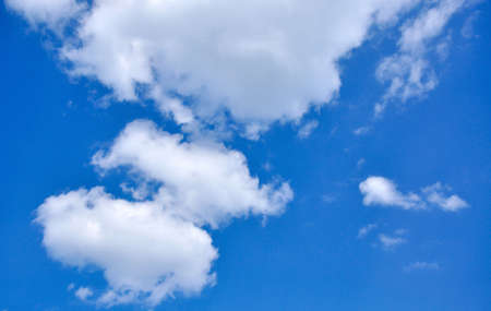 White clouds over the perfect blue skyの写真素材