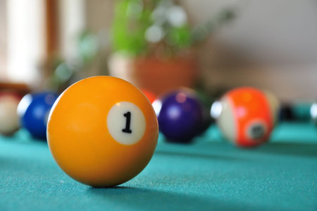 Billiard ball on a billiard table, several balls in blurry background