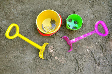 Two shovels and two buckets on sand. の写真素材