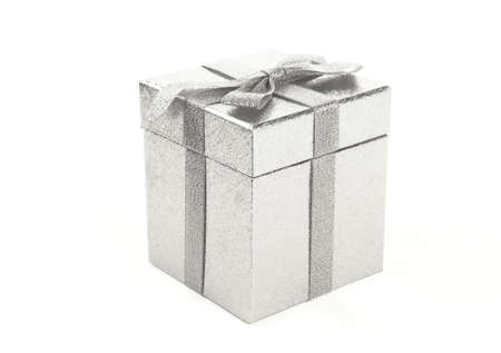 Christmas silver gift-box on white background, with silver ribbonの写真素材