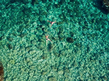 Swimming in the clear sea of the remote island of PalagruÅ¾a in the Croatian Adriaticの写真素材