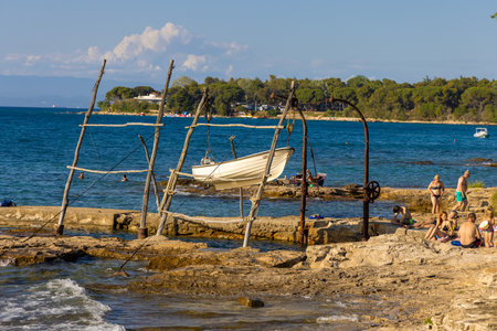 Hanging boats of Savudrija Boats hanging from traditional wooden cranesのeditorial素材