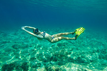 A young woman is free diving on the Adriatic Sea, Croatiaのeditorial素材