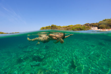 A young woman is free diving on the Adriatic Sea, Croatiaのeditorial素材