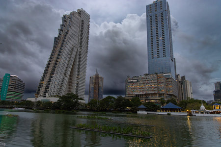 Modern Colombo skyline overlooking a lakeside with floating islands and egrets, Sri Lankaのeditorial素材