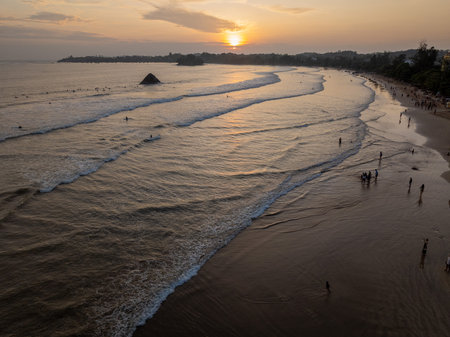 Aerial view of Weligama Beach at sunset with surfers and evening light, Sri Lankaのeditorial素材