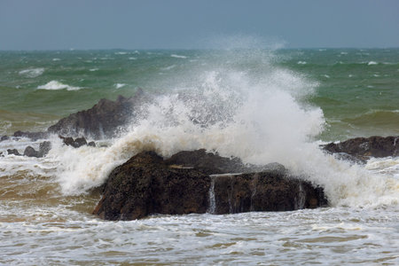 Stormy ocean waves crashing against coastal rocks in Sri Lankaのeditorial素材
