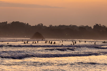 Public town beach in Weligama at sunset with surfers, Sri Lankaのeditorial素材