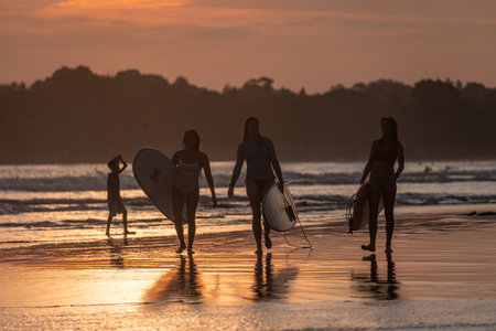 Public town beach in Weligama at sunset with surfers, Sri Lankaのeditorial素材