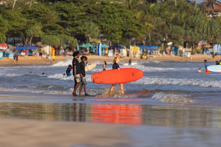 Public town beach in Weligama, Sri Lanka with people in the late afternoonのeditorial素材