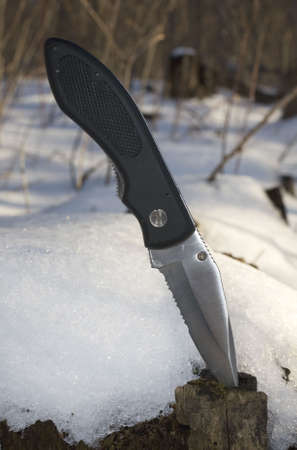 hunting knife during a snowy winter dayの写真素材