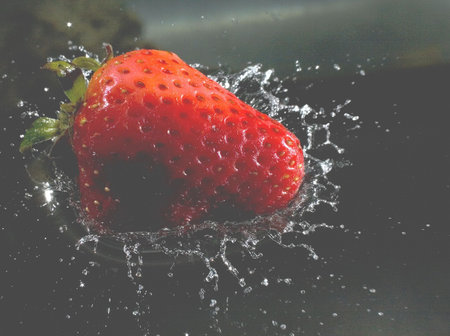the moment when a strawberry hits water