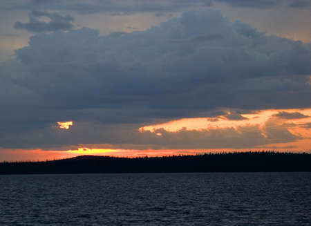 sunset over a lake in the middle of Quebec Canadaの写真素材